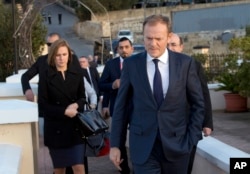 European Council President Donald Tusk, second right, prepares to address the media prior to an EU summit outside his hotel in Valletta, Malta, Feb. 2, 2017.