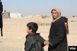 In the suburbs of Mosul, women seek food and medical care near army outposts. They say along with cruel indignities, Islamic State militants also brought with them wide scale extreme poverty on Nov. 19, 2016. (Photo: H.Murdock/VOA)