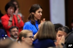 Nadia Murad, a member of the Yazidi religious minority in Iraq and former captive and sex slave of the terrorist group Islamic State, is recognized by Vice President Mike Pence during a speech at the State Department, July 26, 2018.