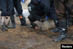 Police detain a man in an attempt to clear the Oceti Sakowin camp, Feb. 23, 2017.