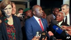 FILE - Burundi's President Pierre Nkurunziza, center, and U.S. ambassador to the U.N. Samantha Power, left, speak to the media in Gitega, Burundi, Jan. 22, 2016.