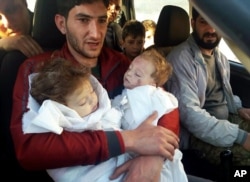 Abdul-Hamid Alyousef, 29, holds his twin babies who were killed during a suspected chemical weapons attack, in Khan Sheikhoun in the northern province of Idlib, Syria, April 4, 2017.