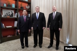 U.S. Secretary of State Mike Pompeo poses with Vice Chairman of the North Korean Workers' Party Committee Kim Yong Chol, North Korea's lead negotiator in nuclear diplomacy with the United States, and U.S. Special Representative for North Korea Stephen Biegun as they start talks aimed at clearing the way for a second U.S.-North Korea summit at a hotel in Washington, Jan. 18, 2019.