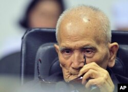In this photo released by the Extraordinary Chambers in the Courts of Cambodia, Nuon Chea, who was the Khmer Rouge's chief ideologist and No. 2 leader, sits in a courtroom before a hearing at the U.N.-backed war crimes tribunal in Phnom Penh, Cambodia, Nov. 16, 2018.