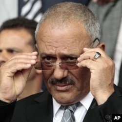 Yemen's President Ali Abdullah Saleh adjusts his glasses during a rally in Sanaa, Apr 22 2011