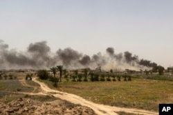 Smoke rises from Islamic State positions at the front line during fight against IS outside Fallujah, May 28, 2016.