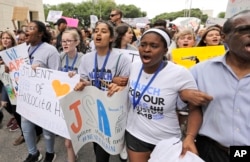 Demonstrators in downtown Houston during a March for Our Lives protest for gun legislation and school safety, March 24, 2018.