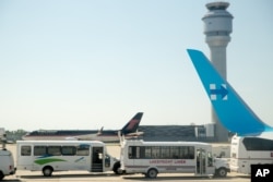 Republican presidential candidate Donald Trump's plane is visible on the tarmac as Democratic presidential candidate Hillary Clinton arrives at Cleveland Hopkins International Airport in Cleveland, Ohio, Sept. 5, 2016, after traveling from Westchester County.
