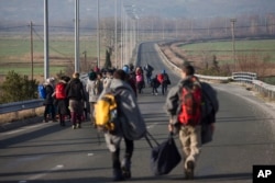 Refugees and migrants make their way to reach the borderline to Macedonia, near the northern Greek village of Idomeni, Feb. 23, 2016.
