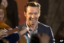 Actor Hugh Jackman signs autographs after a press conference for the movie "Logan" in Beijing, March 1, 2017. He'll star late this year as P.T. Barnum in "The Greatest Showman," with music by "La La Land" lyricists Benj Pasek and Justin Paul.