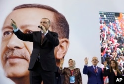 FILE - Turkey's President Recep Tayyip Erdogan gestures as he speaks during a rally of his ruling Justice and Development Party's supporters, in Mersin, southern Turkey, March 10, 2018.