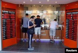People change money at a currency exchange office in Istanbul, Turkey, Aug. 13, 2018.