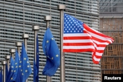 FILE - U.S. and European Union flags are pictured at European Commission headquarters in Brussels, Belgium
