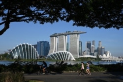 People make their way along the park connector at Marina Bay East as they enjoy the holiday to mark the country's National Day holiday in Singapore on August 9, 2021.