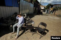 Alicia Espinal reacts during the funeral of her brother Nelson Espinal, 28, Dec. 19, 2018. who was shot to death the night before shortly after leaving his home in Tegucigalpa, Honduras.