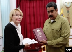 FILE - Venezuelan President Nicolas Maduro, right, talks with Attorney General Luisa Ortega during a meeting at Miraflores presidential palace in Caracas, April 1, 2017.