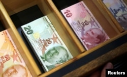 Turkish lira banknotes are pictured at a currency exchange office in Istanbul, Turkey, Aug. 13, 2018.
