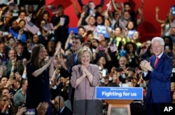 Democratic presidential candidate Hillary Clinton, center, celebrates on stage with her family, from left, Chelsea Clinton, Mark Mezvinsky, and husband former president Bill Clinton, right, at her victory party after winning the New York state primary, April 19, 2016.