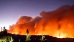 FILE - Seen in a long camera exposure, the Caldor Fire burns on Aug. 29, 2021, in Eldorado National Forest, Calif.