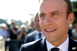 French President Emmanuel Macron meets people after voting in the final round of parliamentary elections, in the northern seaside town of Le Touquet, France, June 18, 2017.