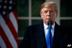 FILE - President Donald Trump, pictured in the White House Rose Garden, says he'll declare a national emergency in order to build a wall along the southern U.S. border, Feb. 15, 2019, in Washington.