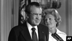 FILE - President Richard M. Nixon and his wife, Pat Nixon, stand together in the East Room of the White House in Washington, Aug. 9, 1974.