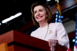 FILE - House Speaker Nancy Pelosi of California smiles during her weekly news conference on Capitol Hill in Washington, Oct. 21, 2021.