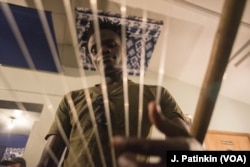 Daniel Onyango looks through the strings of his nyatiti.