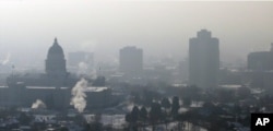 FILE - Haze from an inversion hangs over downtown Salt Lake City, Jan. 7, 2013.