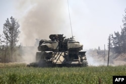 Pro-Syrian regime forces advance toward the town of Douma, the last opposition holdout in eastern Ghouta, April 7, 2018, after regime troops resumed a military blitz to pressure rebels to withdraw.