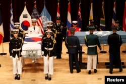 South Korean and the United Nations Command honor guards carry the remains of United Nations Command and South Korean soldiers killed in North Korea in the 1950-53 Korean War during the mutual repatriation ceremony of soldiers' remains between South Korea and U.S at the Seoul National Cemetery in Seoul, South Korea, July 13, 2018.