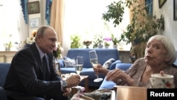 Russia's President Vladimir Putin congratulates the head of the Moscow Helsinki Group, Lyudmila Alekseyeva, on her 90th birthday during a meeting in Moscow, July 20, 2017.