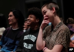 New York University students react while watching the presidential debate between Democratic candidate Hillary Clinton and Republican candidate Donald Trump during a debate watch gathering in New York, Oct. 19, 2016.