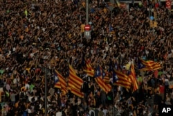 Protesters with ''esteladas'' or Catalonia independence flags pack the University square during a one-day strike in Barcelona, Spain, Tuesday Oct. 3, 2017.