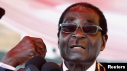 Zimbabwe's President Robert Mugabe addresses the crowd gathered to commemorate Heroes Day in Harare, Aug. 12, 2013.