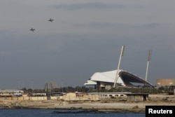 FILE - Russian warplanes fly over the Mediterranean coastal city of Latakia, Syria.