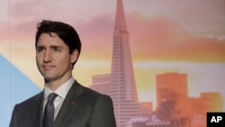 Canada's Prime Minister Justin Trudeau waits to speak at the AppDirect office in San Francisco, Feb. 8, 2018.
