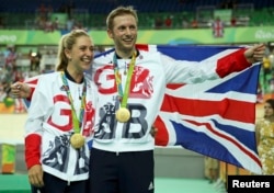 Gold medalist Jason Kenny of Britain poses with his girfriend, women's omnium gold medalist Laura Trott of Britain, at the Olympic Games in Rio de Janeiro, Brazil, Aug. 16, 2016.