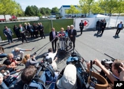 German Chancellor Angela Merkel addresses the media after her visit to a refugee shelter that was attacked by far-right protesters over the weekend in Heidenau, eastern Germany, Aug. 26, 2015.