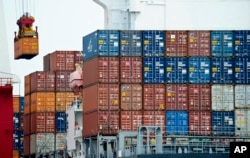 FILE- A container is loaded onto a cargo ship at the Tianjin port in China, Aug. 5, 2010. With the apparent death of the Trans-Pacific Partnership, China sees a chance at forming its own Pacific free trade area
