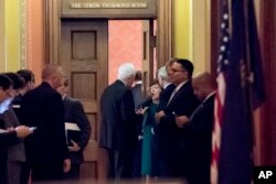 FILE - Republican senators gather to meet with Senate Majority Leader Mitch McConnell on the Repblican effort to overhaul the U.S. tax code, on Capitol Hill, in Washington, Dec. 1, 2017. A vote on the bill could be held as early as next week.