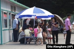 People line up to eat at a food kiosk in Pyongyang, North Korea.