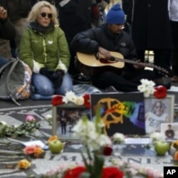 John Lennon fans gather at the Imagine Mosaic in the Strawberry Fields section of Central Park on the 30th anniversary of the death of former Beatle John Lennon in New York, December 8, 2010.