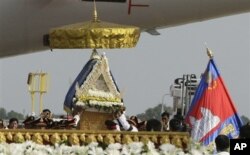 FILE - Police officers carry a casket carrying the body of Cambodia's late King Norodom Sihanouk upon arrival from Beijing at Phnom Penh International Airport in Phnom Penh, Cambodia, Wednesday, Oct. 17, 2012. (AP)