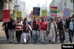 FILE - Activists of the leftist alliance join in a rally to demand a new election under caretaker government, in Dhaka, Bangladesh, Jan. 3, 2019.