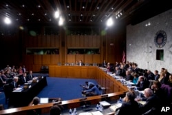 FILE - At left, Facebook's General Counsel Colin Stretch, accompanied by Twitter's Acting General Counsel Sean Edgett, and Google's Law Enforcement and Information Security Director Richard Salgado, speaks during a Senate Committee on the Judiciary, Subcommittee on Crime and Terrorism hearing on Capitol Hill in Washington, Oct. 31, 2017.
