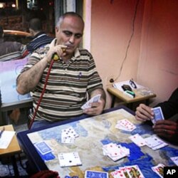 Palestinian-American Ibrahim Mussa plays cards in a Ramallah cafe