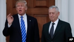 FILE - President-elect Donald Trump talks to the media as he stands with retired Marine Corps Gen. James Mattis at the Trump National Golf Club Bedminster clubhouse in Bedminster, N.J., Nov. 19, 2016.