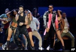 FILE - Luis Fonsi, left and Daddy Yankee perform during the Latin Billboard Awards in Coral Gables, Fla.