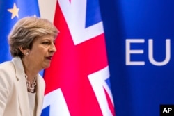FILE - British Prime Minister Theresa May prepares to address a media conference at an EU summit in Brussels, June 23, 2017. May appears to be looking into an EFTA membership as an alternative to a "hard Brexit."